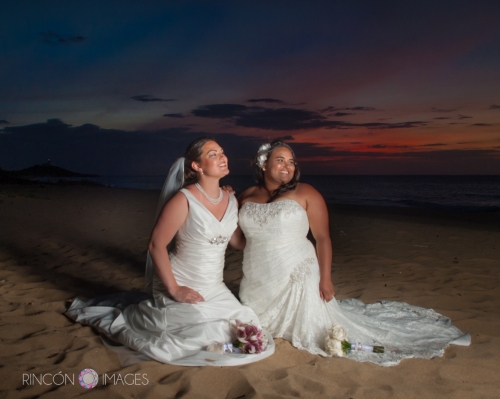 A beautiful sunset with two LGBT brides on the beach in Puerto Rico after their wedding ceremony.